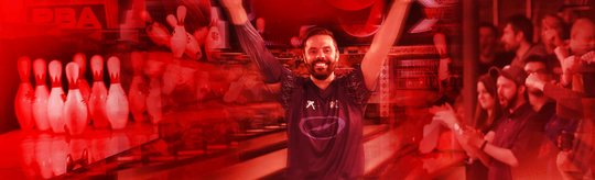 Jason Belmonte cheering in front of lanes and an audience