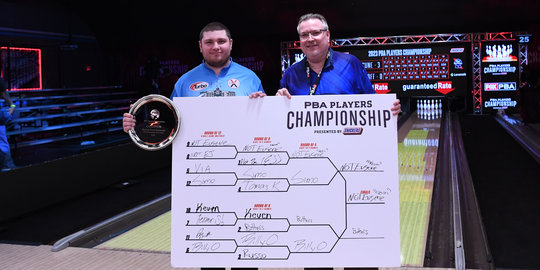 Kevin and Eugene McCune pose with the PBA Players Championship presented by Snickers bracket and trophy.